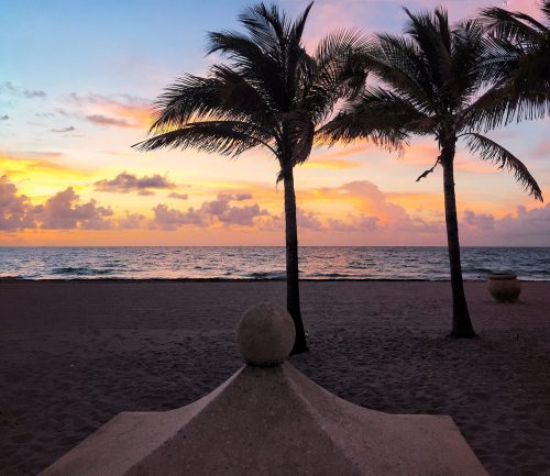 silhouette-palm-trees-beach-against-sky-sunset-min